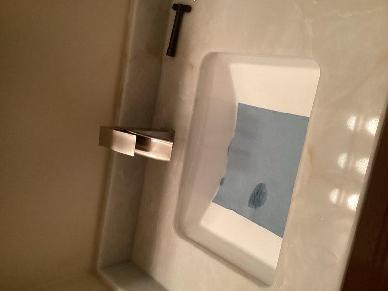 Completed installation of two customer-supplied lavatory faucets in bathroom vanity areas. Both faucets were successfully mounted to white countertops with integrated sink basins, with all water supply connections properly secured and tested for leaks. All fixtures are functioning correctly with proper hot and cold water flow confirmed upon completion.