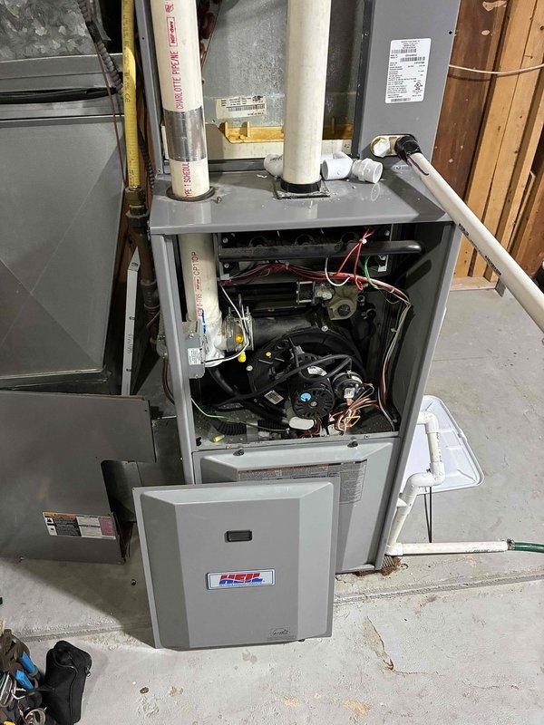 Responded to no-cooling complaint on 16-17 year old Heil HVAC system with water leakage issue. Found homeowner had previously cut and cleared condensate drain line, routing it directly to sink without proper fittings. Upon inspection, verified evaporator coil was clean and not frozen, and confirmed all drain fittings and lines were clear of obstructions. Conducted water test by pouring water into drain pan, which revealed water running down exterior side of furnace, indicating hairline crack in drain pan that could not be visually located despite multiple inspection attempts with camera. Explained to homeowner that repair would require complete evaporator coil removal and replacement. Given the advanced age of the system and cost of repair versus replacement, recommended full system upgrade rather than investing in major repairs on aging equipment, which homeowner accepted. Left temporary drain configuration in place pending equipment replacement decision.
