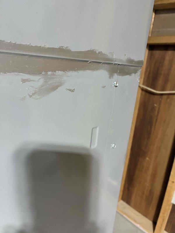 Responded to no-cooling complaint on 16-17 year old Heil HVAC system with water leakage issue. Found homeowner had previously cut and cleared condensate drain line, routing it directly to sink without proper fittings. Upon inspection, verified evaporator coil was clean and not frozen, and confirmed all drain fittings and lines were clear of obstructions. Conducted water test by pouring water into drain pan, which revealed water running down exterior side of furnace, indicating hairline crack in drain pan that could not be visually located despite multiple inspection attempts with camera. Explained to homeowner that repair would require complete evaporator coil removal and replacement. Given the advanced age of the system and cost of repair versus replacement, recommended full system upgrade rather than investing in major repairs on aging equipment, which homeowner accepted. Left temporary drain configuration in place pending equipment replacement decision.