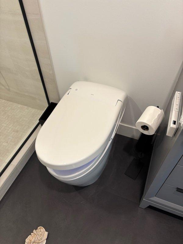 Removed existing toilet from upstairs bathroom and staged in storage room per homeowner's request. Installed customer-supplied Toto G5A bowl and Washlet bidet seat, making all necessary water supply and electrical connections. Upon completion, performed pressure testing to verify no leaks were present, then conducted full operational testing of all Washlet functions including spray settings, heated seat, and control panel operations. All features tested and confirmed working properly. Left unit in service with work area cleaned.