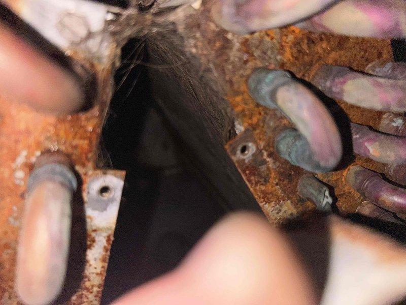 Responded to no cooling complaint on 26-year-old central air conditioning system running but unable to maintain temperature. Upon arrival, found evaporator coil frozen solid. Allowed coil to thaw sufficiently to perform diagnostics. Verified adequate airflow across coil once thawed. Performed refrigerant charge check and confirmed system was significantly low on R-22 refrigerant. Inspected outdoor condenser unit and refrigerant lines, noting severe corrosion and rust deterioration on copper piping connections and mounting hardware, indicating age-related degradation and potential leak points. System showing multiple signs of end-of-life failure including refrigerant loss, corroded components, and diminished cooling capacity. Given the age of the equipment, obsolete R-22 refrigerant requirements, extent of corrosion damage, and cost of repairs versus replacement, provided customer with comprehensive pricing options for both refrigerant recharge repair and complete system replacement. Co