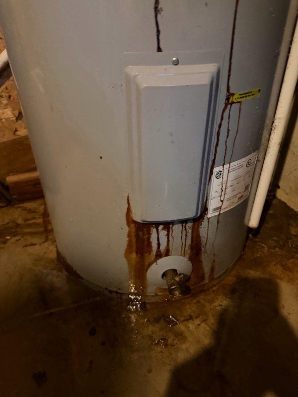 Responded to service call for leaking water heater with no hot water. Upon inspection, found AO Smith water heater originally installed in 2021 experiencing active leak from element port area with visible water pooling at base and significant rust staining on lower tank section. Confirmed unit is still under manufacturer warranty valid through 2027. Documented blowout condition at element port with photographs showing corrosion damage and water accumulation. Determined warranty replacement is required due to tank failure. Unable to complete replacement on initial visit as parts supplier was closed for weekend. Scheduled return appointment to install warranty replacement water heater once new unit is obtained from supplier.