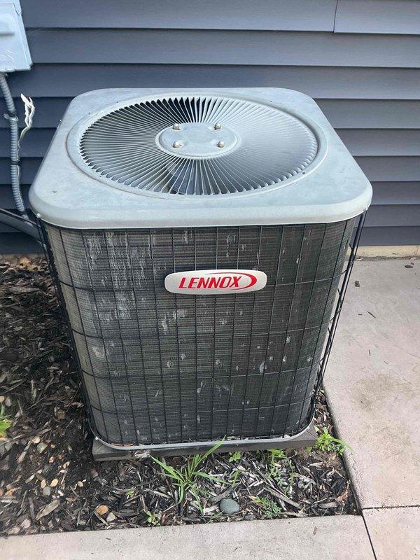 Responded to callback on 21-year-old Lennox AC system that stopped cooling shortly after previous service visit. Upon arrival, found that contactor was not receiving 24V during call for cooling despite recent contactor and capacitor replacement. Diagnosed issue as loose AC communication wire at furnace terminal strip—wire had fallen out of common terminal, likely due to blower vibration. Common terminal was overloaded with five wires. Reinstalled loose wire onto board and secured connection to prevent future disconnection. Cycled system through complete cooling cycle and verified proper 24V signal to contactor, compressor operation, and adequate cooling performance. System restored to normal operation.