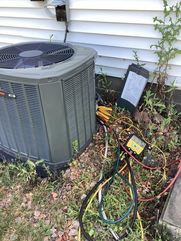 Responded to no-cool call on 10-year-old residential air conditioning system. Upon arrival, unit was operational but condenser coil showed significant debris accumulation and biological growth. Performed complete system diagnostics using manifold gauges to verify refrigerant pressures and temperatures. Inspected compressor, fan motor, and capacitor connections, noting heavy rust and corrosion on motor terminal assembly with multiple wire connections showing age-related deterioration. Thoroughly cleaned condenser coil to remove buildup that was restricting airflow and reducing system efficiency. All electrical connections tested and verified secure despite visible corrosion. System operational at departure with normal operating pressures and temperatures. Advised customer that regular coil maintenance is essential to prevent future performance issues and that corroded electrical components should be monitored closely given system age.