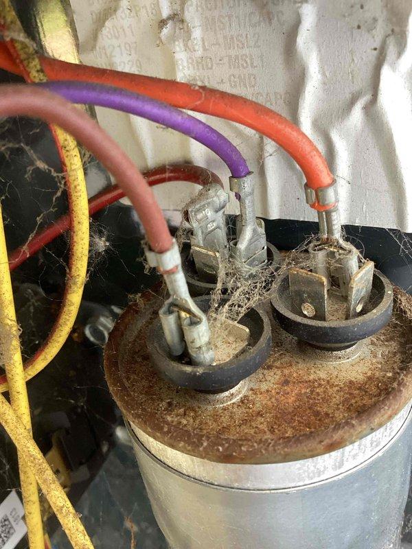Responded to no-cool call on 10-year-old residential air conditioning system. Upon arrival, unit was operational but condenser coil showed significant debris accumulation and biological growth. Performed complete system diagnostics using manifold gauges to verify refrigerant pressures and temperatures. Inspected compressor, fan motor, and capacitor connections, noting heavy rust and corrosion on motor terminal assembly with multiple wire connections showing age-related deterioration. Thoroughly cleaned condenser coil to remove buildup that was restricting airflow and reducing system efficiency. All electrical connections tested and verified secure despite visible corrosion. System operational at departure with normal operating pressures and temperatures. Advised customer that regular coil maintenance is essential to prevent future performance issues and that corroded electrical components should be monitored closely given system age.