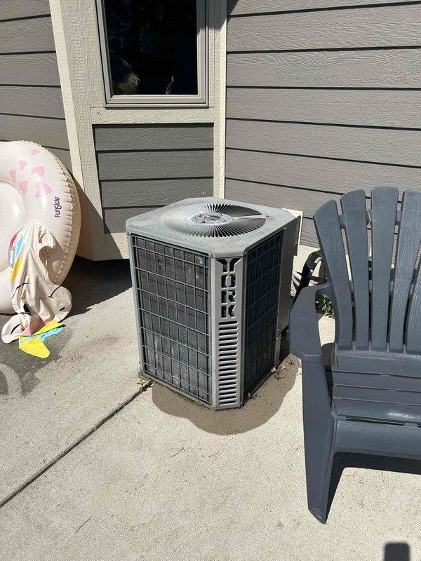 Responded to no cooling complaint on 15-year-old York central air conditioning system with indoor temperature at 78°F. Upon arrival, found evaporator coil completely frozen with severely clogged air filter restricting airflow. Removed plugged filter and left blower running in fan-only mode to thaw frozen coil. Advised homeowner that once coil is fully thawed, system should be restarted to verify proper cooling operation. Informed homeowner that if cooling issues persist after thaw cycle completes, a refrigerant leak or low charge is likely and system replacement should be considered given age of equipment.