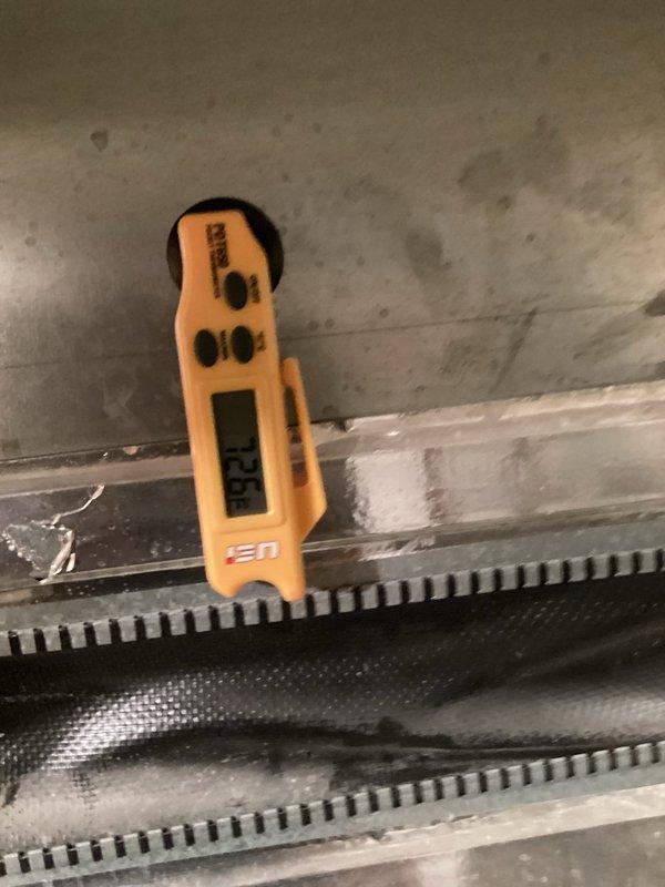 Responded to no-cool complaint on 9-year-old residential air conditioning system unable to maintain setpoint of 73°F, holding at 78°F. Upon arrival, found A/C unit running continuously but providing insufficient cooling to the residence. Performed diagnostic evaluation of system operation and measured temperature differentials across the evaporator coil using digital thermometer.

Inspection revealed evaporator coil exhibiting ice formation, indicating low refrigerant charge. Confirmed system was operating with inadequate refrigerant levels, causing reduced cooling capacity and coil freeze-up. Low charge condition was preventing proper heat absorption and causing compressor to run continuously without achieving desired indoor temperature.

Advised homeowner to power down system for 24 hours to allow complete defrost of evaporator coil before proceeding with refrigerant service. Shut down unit to prevent potential compressor damage from continued operation in frozen condition. Scheduled