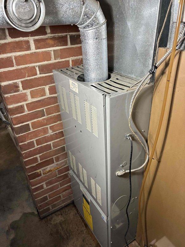 Responded to no cooling complaint affecting entire residence. Upon inspection, diagnosed failed capacitor on outdoor condensing unit. Discussed system age and R-22 refrigerant considerations with homeowner, explaining potential cost implications of future repairs on aging equipment. Per customer request, proceeded with capacitor replacement. Performed condenser coil cleaning and verified air filter condition was acceptable. Inspected oil furnace and confirmed condensate drain line was clear. Connected manifold gauges to measure refrigerant pressures, which were within acceptable operating range. System tested and confirmed restored to normal cooling operation.