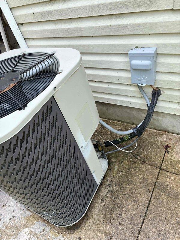 Responded to no cooling complaint affecting entire residence. Upon inspection, diagnosed failed capacitor on outdoor condensing unit. Discussed system age and R-22 refrigerant considerations with homeowner, explaining potential cost implications of future repairs on aging equipment. Per customer request, proceeded with capacitor replacement. Performed condenser coil cleaning and verified air filter condition was acceptable. Inspected oil furnace and confirmed condensate drain line was clear. Connected manifold gauges to measure refrigerant pressures, which were within acceptable operating range. System tested and confirmed restored to normal cooling operation.