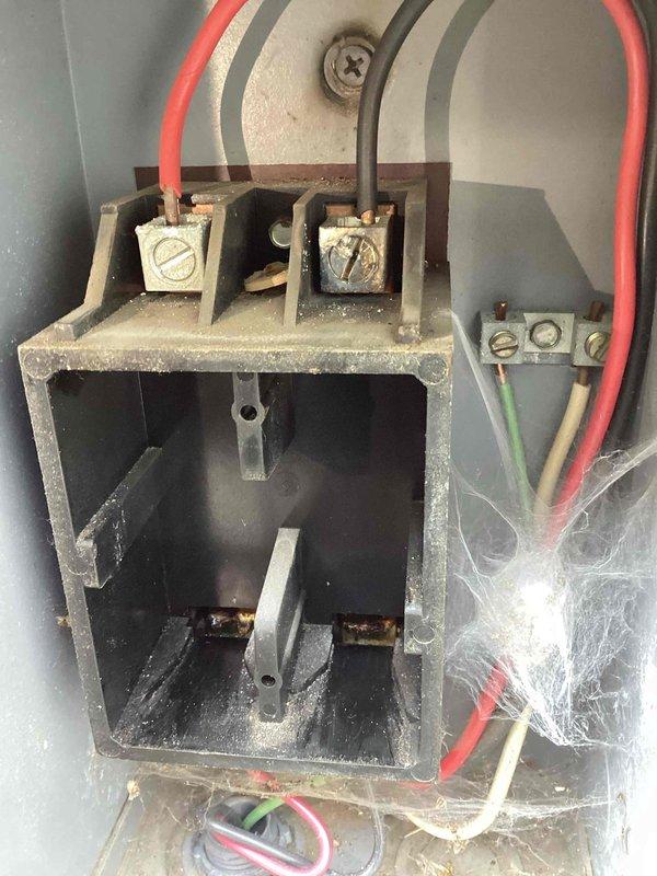 Responded to no cooling complaint on residential air conditioning system under warranty. Upon arrival, performed diagnostic testing and discovered no power supply to the outdoor condensing unit. Using multimeter, verified absence of voltage at the equipment disconnect and traced issue back to the main electrical panel. Determined that the problem originated from the building's electrical service rather than the HVAC equipment itself. Informed homeowner that a licensed electrician would be required to diagnose and repair the electrical supply issue before air conditioning system could be restored to operation. Documented findings with photos of testing equipment and electrical connections at disconnect box.