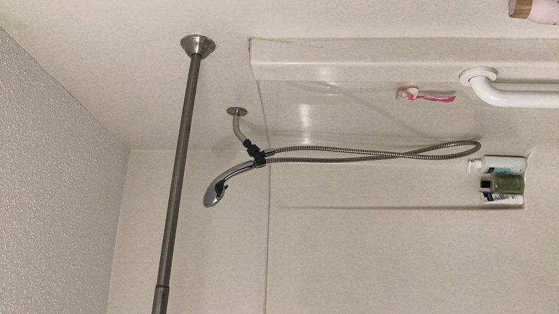 Responded to service call for shower head leaking behind wall. Upon inspection, identified the shower arm as the source of the leak. Although additional potential leaks were observed at the tub spout and tub drain overflow assembly, the customer requested repair limited to the shower arm only. Successfully removed the defective shower arm and installed a new replacement unit, ensuring proper thread seal and secure connection to the water supply line. Verified no active leaks at the shower arm connection point upon completion and restored full shower functionality.