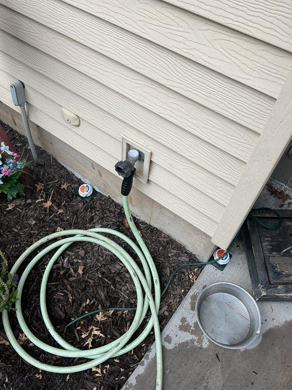 Responded to call regarding leaking outdoor hose bibb. Upon arrival, identified old Mansfield hose bibb mounted on exterior siding showing signs of deterioration and active leak. Shut off water supply at interior basement shut-off valve. Removed failed hose bibb and mounting hardware from exterior wall. Installed new brass hose bibb with proper mounting plate, ensuring secure attachment to wall and proper sealing to prevent future leaks. Restored water supply and tested new installation for leaks and proper operation. Verified hose connection functionality with existing garden hose and confirmed no drips or leaks at spigot or wall penetration.