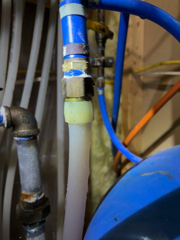 Responded to water leak in mechanical room originating from 8-12 union fitting on water line connected to pressure tank. Upon inspection, identified failed Kitec plumbing system with multiple deteriorating fittings throughout the residence. Customer had applied temporary repair using hose clamps to slow the leak. Documented existing conditions with photographs showing corroded brass fittings, makeshift clamp repairs, and compromised connections. Arranged for emergency estimate consultation to address immediate mechanical room repairs and evaluate complete home re-piping to eliminate failing Kitec components and prevent future system failures.