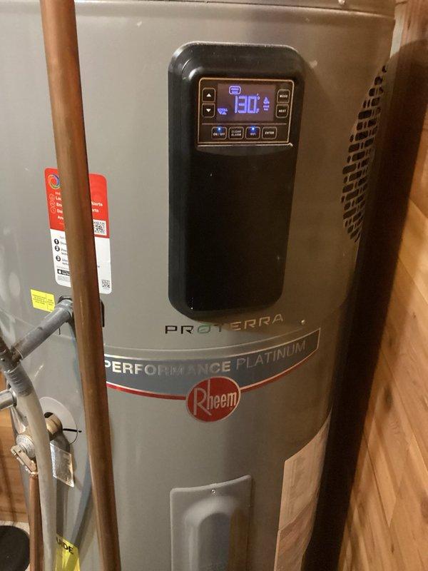 Responded to service call for Rheem ProTerra Performance Platinum heat pump water heater displaying error code A108, indicating condensate drain blockage with heating source defaulting to backup elements. Upon arrival, verified unit was producing hot water and operating on electric elements. Inspected condensate drainage system including rope sensor, drain tube, and drain line connections. Found rope sensor dry with no moisture present and confirmed drain line clear of obstructions with no residual water accumulation. Performed vacuum test on condensate fitting to verify proper drainage flow. Disconnected and reconnected rope sensor to test system response; alarm persisted after brief interval despite clear drainage path. Based on diagnostic findings—clear drain lines, dry sensor, and recurring alarm code despite proper drainage—determined likely failure of condensate rope sensor itself rather than actual blockage condition. Confirmed unit remains under manufacturer warranty coverage. 