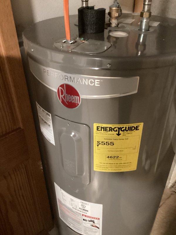 Responded to service call for water heater code compliance issues. Upon inspection, found Rheem Performance water heater installed without proper temperature and pressure relief valve discharge pipe, creating a safety hazard. Installed discharge pipe on relief valve per plumbing code requirements. Water heater requires elevation of 6 inches to meet current code standards and has multiple water lines that need to be capped for proper system operation.