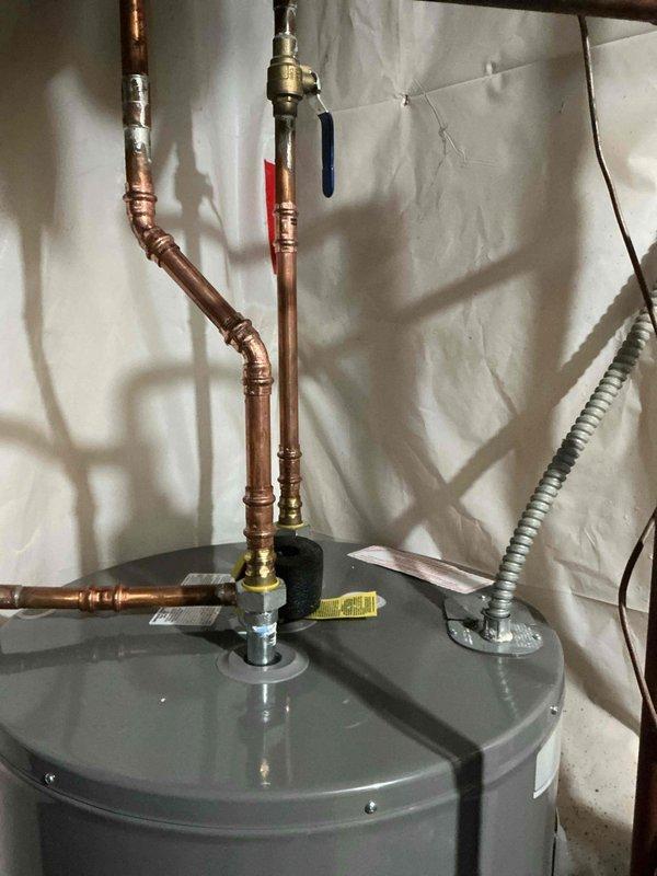 Responded to service call for leaking 50-gallon water heater and 8-12 water softener system installed four years prior. Completed warranty replacement of the leaking water heater unit, including removal of failed equipment and installation of new water heater with proper copper piping connections, brass ball valves, and electrical connections per manufacturer specifications and local plumbing codes.