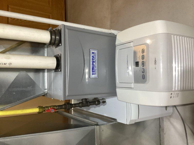 Responded to service call for 10+ year old 50-gallon electric water heater actively seeping from the bottom. Assessed unit and discussed replacement options with customer, including tankless gas and electric alternatives with various venting configurations. Customer elected to proceed with like-for-like replacement. Removed and disposed of failed electric water heater, installed new 50-gallon electric unit with proper connections to existing copper supply lines and electrical service, verified all connections for leaks, tested operation, and restored hot water service to the residence.