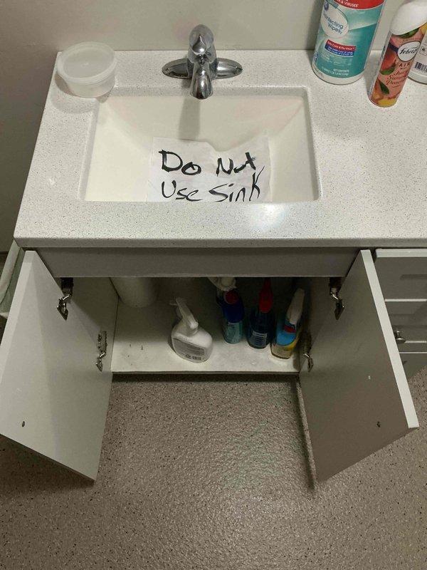 Responded to a bathroom sink leak complaint where water was draining into the vanity cabinet. Upon diagnostic inspection, discovered the tail piece connecting to the P-trap assembly was completely disconnected, causing all drainage to bypass the trap and leak directly into the cabinet space. Removed the existing trap assembly, properly reconnected and secured the tail piece to the drain outlet, and reinstalled the P-trap ensuring all compression fittings were tightened to manufacturer specifications. Performed operational testing by running water through the fixture at various flow rates to verify proper drainage and confirmed no leaks were present at any connection points. Sink restored to full operational status.