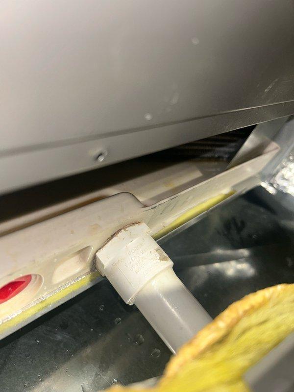 Responded to a service call for a Lennox air conditioning system experiencing water leakage while maintaining cooling capacity. Upon inspection, diagnosed a clogged condensate drain line as the primary issue. Utilized wet vacuum to extract accumulated condensation water from the drain pan and line, then cleared the blockage using compressed CO2. Thoroughly inspected evaporator coils and drain pan, confirming no damage or additional leaks present. Performed comprehensive cleaning of both interior and exterior sections of the condensate drain line using vacuum extraction methods. Flushed drain system with 2-3 gallons of water to verify proper flow and confirmed audible drainage through wall cavity, indicating complete line clearance. System tested and verified to be cooling normally with condensate draining properly through cleared line. Unit restored to full operational status.