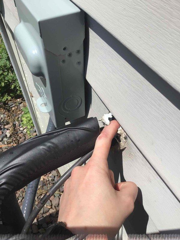 Responded to callback for water accumulation under recently installed furnace and moisture spots on basement drywall. Upon inspection, found no leaks from HVAC system components or condensate lines. Investigation revealed failed sealant around lineset penetration at exterior wall, allowing rainwater infiltration. Water traveled through lineset insulation and dripped at furnace location. Removed old silicone and properly sealed exterior penetration to prevent further water intrusion.