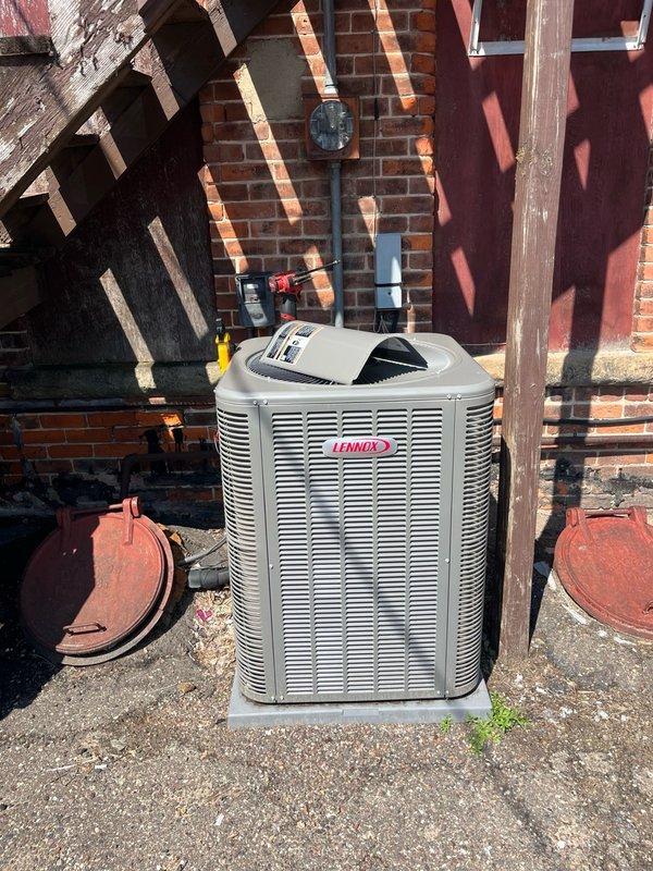 Responded to no cooling complaint at commercial facility with indoor temperatures exceeding 80 degrees. Upon arrival, discovered both A/C units were non-operational following a Friday power outage. Located tripped breakers inside building for both systems. 

Inspected newer Lennox unit and found condenser coils severely restricted with debris, causing unit to run hot and trip on thermal overload. Performed complete system cleaning and tune-up, including coil cleaning and operational check. Unit restored to proper operation with normal temperature differential.

Evaluated older unit which repeatedly tripped breaker during testing. Diagnosed compressor drawing excessive starting amperage, indicating internal wear and impending failure. Compressor showing signs of age-related deterioration affecting motor windings. Discussed repair options including hard start capacitor installation as temporary measure, but advised this would only provide short-term relief. Recommended obtaining estimate