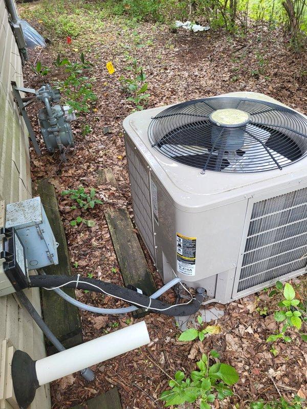 Responded to no cooling call on 2013 ICP air conditioning unit where indoor blower was operational but outdoor unit was not running. Upon inspection, found compressor running but condenser fan motor locked up. Tested dual run capacitor rated at 35/5 µF and measured 33.6/.09 µF, confirming capacitor failure. Replaced defective capacitor, cleaned condenser coil, and performed operational testing using Job Link diagnostics. Verified proper system performance with subcooling measurements between 11-12°, meeting manufacturer specifications for 10° target. Also noted property has Bryant furnace rated at 95+ AFUE efficiency and recommended scheduling preventative maintenance inspection for fall season.