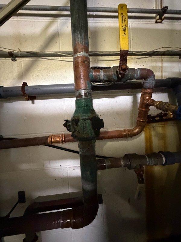 Replaced faulty copper piping and fittings in multiple critical locations including the water treatment bypass, pressure tank area, water heater supply lines, and main supply line. Removed and repiped broken sections of water lines near the pressure tank and bypass for water treatment system, as well as sections located above the water heaters. All work was completed as a bid job with water service coordinated for shutdown during repairs.