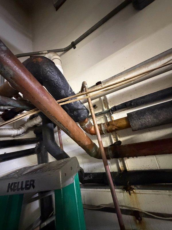 Replaced faulty copper piping and fittings in multiple critical locations including the water treatment bypass, pressure tank area, water heater supply lines, and main supply line. Removed and repiped broken sections of water lines near the pressure tank and bypass for water treatment system, as well as sections located above the water heaters. All work was completed as a bid job with water service coordinated for shutdown during repairs.