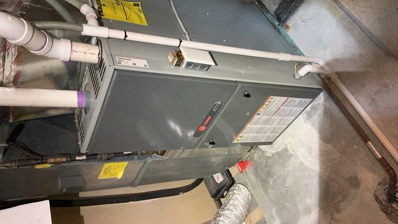 Performed comprehensive service repair on multiple HVAC systems including two Trane furnaces (Model TUH2B080A9V3VBA) and one Bryant furnace (Model 926TA42060V17A-B). Replaced pressure switch and flame sensor on left side Trane unit, replaced flame sensor on right side Trane unit. Replaced noisy inducer draft motor on basement Bryant furnace. Replaced non-functioning humidifier solenoid valve on right side of basement humidifier. All furnace repairs completed successfully and units tested operational.

Conducted tune-up maintenance on six air conditioning systems. Inspected and verified refrigerant levels, contactors, and electrical wiring on all units. Performed coil cleaning by rinsing down condenser coils. Identified failed capacitor reading 0 out of 45 MFD and replaced component. Inspected air filtration—filters found in acceptable condition. All six AC systems tested and confirmed operational and ready for cooling season.