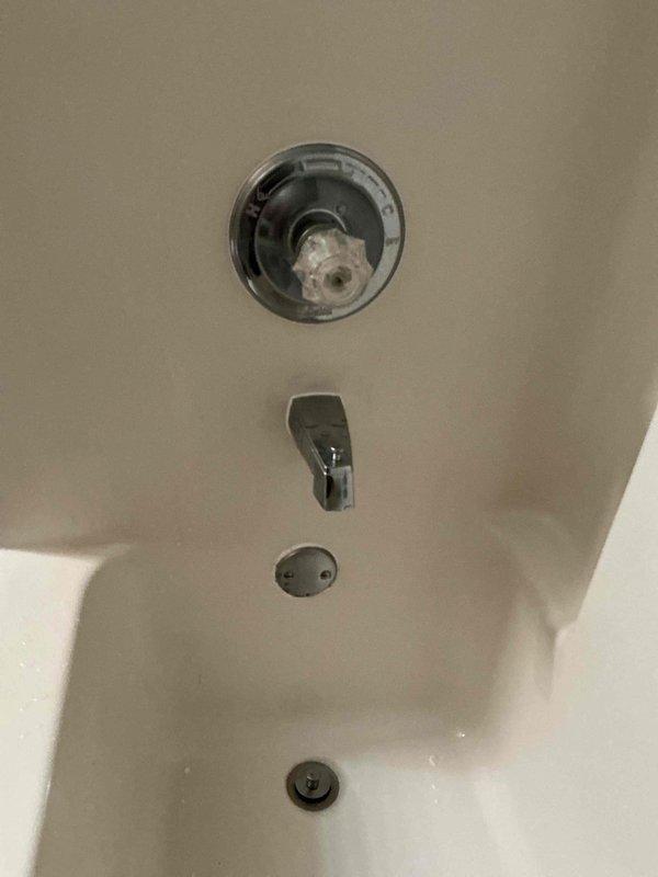 Replaced defective shower rough-in valve body using press tool with offset jaws, requiring enlargement of existing wall access point. Installed Delta Classic Lahara Monitor 14 Series Tub and Shower Trim in chrome finish with remodeler trim plate to cover expanded opening, complete with new valve body assembly and one-year workmanship guarantee.