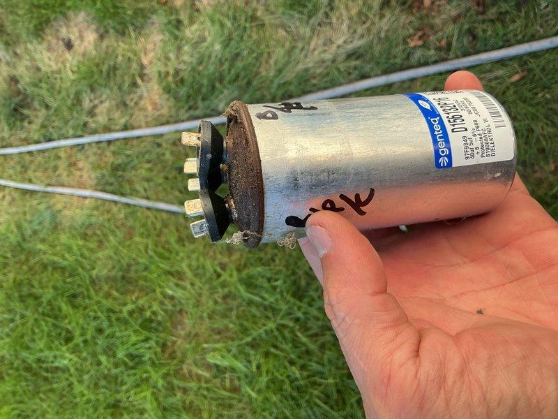 Responded to no cooling complaint with outdoor unit condenser fan failing to start, causing compressor to overheat and shut down after 1-2 minutes of operation. Upon inspection, found failed dual-run capacitor in severely deteriorated condition, visibly bulging and at risk of rupture. Replaced defective capacitor with new unit and restored proper fan motor operation. Performed complete system tune-up including coil cleaning, electrical connection inspection, contactor evaluation, and refrigerant charge verification. All wiring connections, contactors, and refrigerant levels found within normal operating parameters. Advised homeowner to replace dirty air filter. System tested and confirmed operating properly with normal cooling function restored.