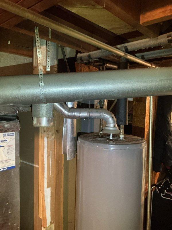 Completed mandatory 8-12 safety inspection on Ruud tanked water heater for city compliance requirements. Performed comprehensive evaluation of unit including visual assessment of tank condition, venting system, pipe connections, and safety components. Verified proper installation of flue ductwork, checked all plumbing connections at top of unit, and confirmed water heater is adequately supported and properly positioned in basement utility area. Documented findings and completed required TISH inspection form for municipal records.