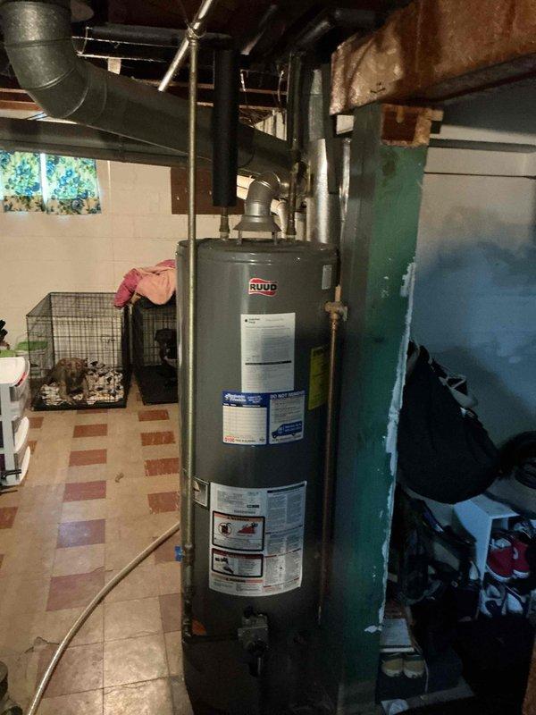 Completed mandatory 8-12 safety inspection on Ruud tanked water heater for city compliance requirements. Performed comprehensive evaluation of unit including visual assessment of tank condition, venting system, pipe connections, and safety components. Verified proper installation of flue ductwork, checked all plumbing connections at top of unit, and confirmed water heater is adequately supported and properly positioned in basement utility area. Documented findings and completed required TISH inspection form for municipal records.