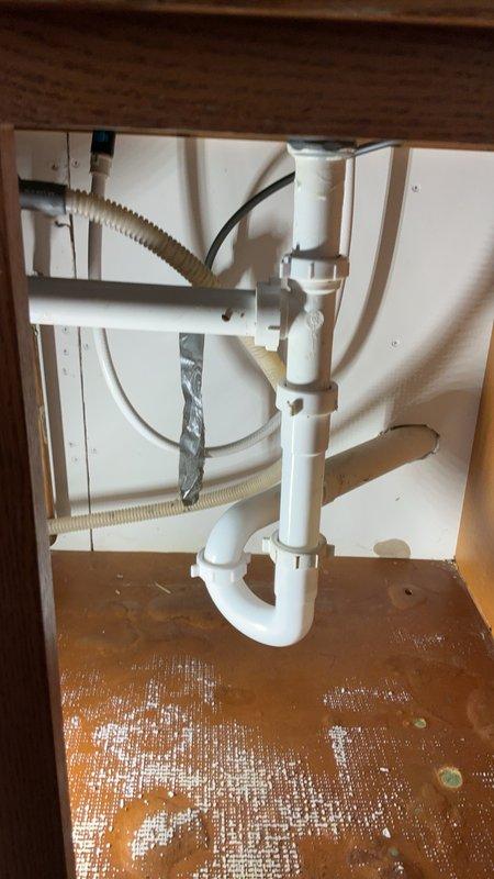 Responded to kitchen sink leak with water pooling on floor. Upon inspection, found P-trap clogged and compression drain fitting gaskets failing, causing water to discharge from drain assembly when faucet was operated. Cleared obstruction from trap, replaced deteriorated gaskets, and installed new sections of drain pipe beneath sink to restore proper drainage and eliminate leaks. Additionally, cleared blockage from cold water side of laundry sink to restore full water flow. Cleaned work area, tested all fixtures for proper operation, and confirmed no active leaks present upon completion.