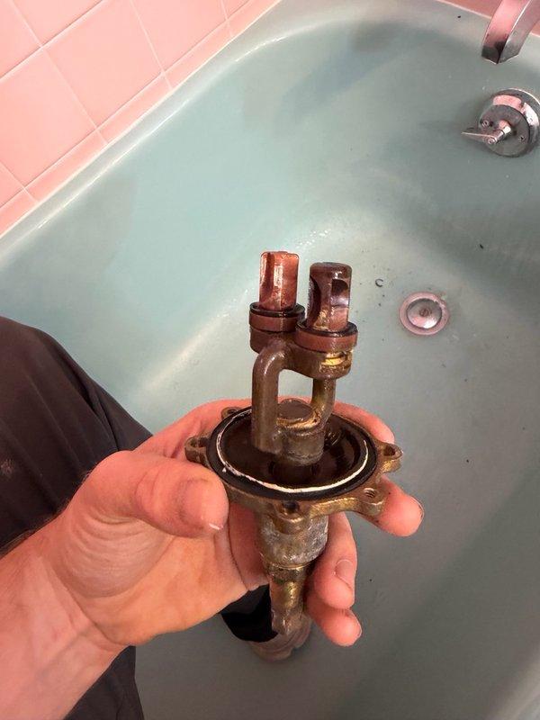 Completed full rebuild of Kohler tub/shower mixing valve assembly. Disassembled corroded valve body, replaced all internal cartridge components, seals, and hardware due to extensive mineral buildup and deterioration. Reinstalled valve assembly with new mounting hardware and tested operation to ensure proper water flow and temperature control.