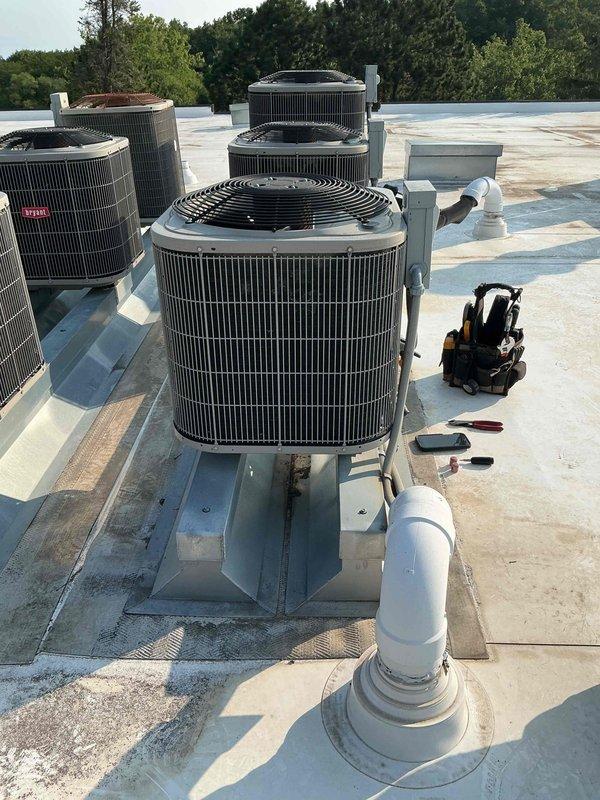 Completed annual air conditioning maintenance on an 11-year-old rooftop unit. Performed comprehensive system inspection including contactor, capacitor, refrigerant charge, condenser coil cleanliness, amperage draws, and air filter condition—all components found to be in good working order. Temperature drop measured at 18 degrees, confirming proper system operation with no deficiencies identified.