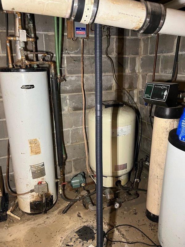 Responded to water leak in basement originating from central air conditioning system above furnace. Diagnosed plugged condensate drain line as primary cause of water overflow. Cleared blockage from evaporator coil condensate line and verified proper drainage from drain pan. Replaced heavily soiled air filter. Inspected outdoor condensing unit and confirmed all components operating within manufacturer specifications, noting age-related wear on select components. Performed operational test of complete AC system for 15 minutes, verified 16-18 degree temperature split across evaporator coil, and confirmed system functioning properly with no further leakage.