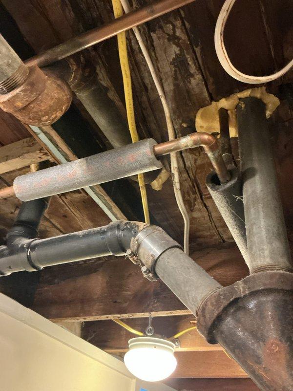 Responded to water leak causing basement flooding from upstairs bathroom. Identified source as failed caulking and grout deterioration around bathtub tile joints and soap dish fixture. Removed old caulking, cleaned and prepared surfaces, and re-caulked all tile joints to create proper water barrier and prevent further water intrusion into basement below.