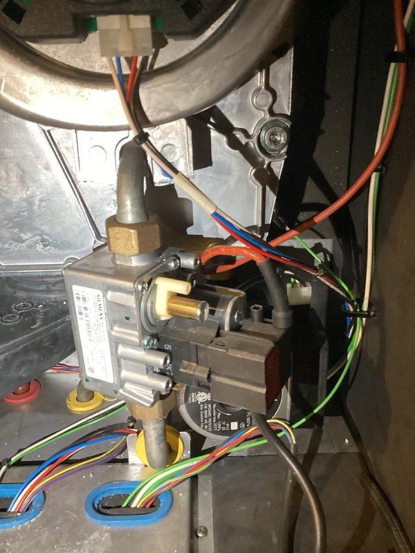 Completed annual boiler maintenance visit on a 3-year-old unit. Thoroughly cleaned heat exchanger which showed significant dust and dirt accumulation on vertical fins and honeycomb mesh structure. Inspected and verified proper system drainage, confirmed ignitor and sensor are in good operating condition, and verified gas valve assembly and control wiring connections are secure and functioning correctly.