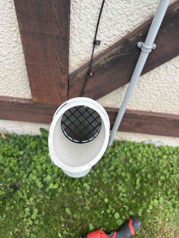 Returned to property to install bird screen on boiler vent termination as preventative measure against pest intrusion. Successfully installed black mesh screening over white PVC vent pipe protruding from exterior wall, securing protection at the termination point to prevent birds and debris from entering the venting system while maintaining proper airflow and combustion air requirements.