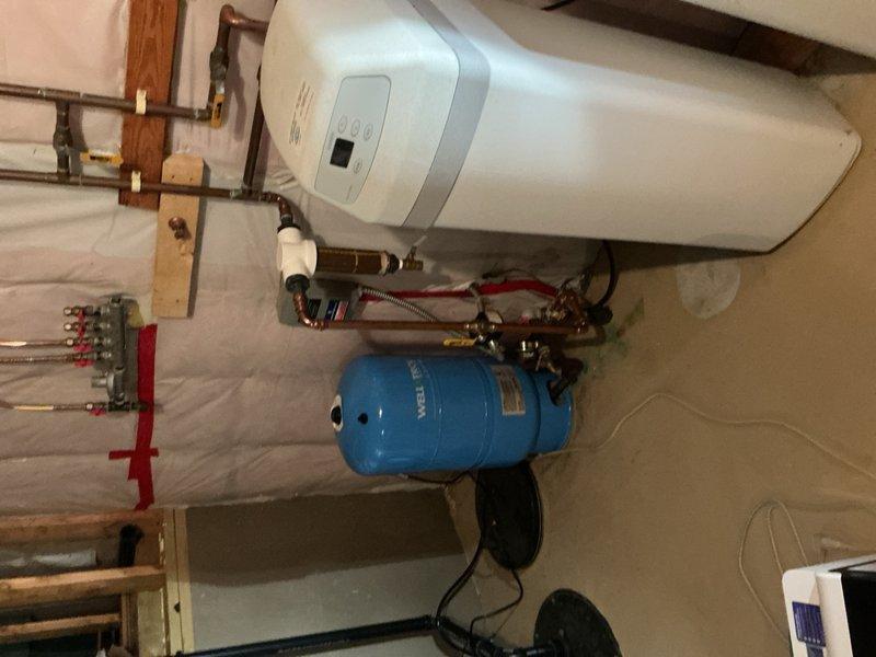 Completed comprehensive plumbing inspection of residential property, examining water heater system, pressure tank, copper piping, shut-off valves, and fixture connections throughout the home. All components were photographed and found to be in proper working condition with no immediate repairs required.