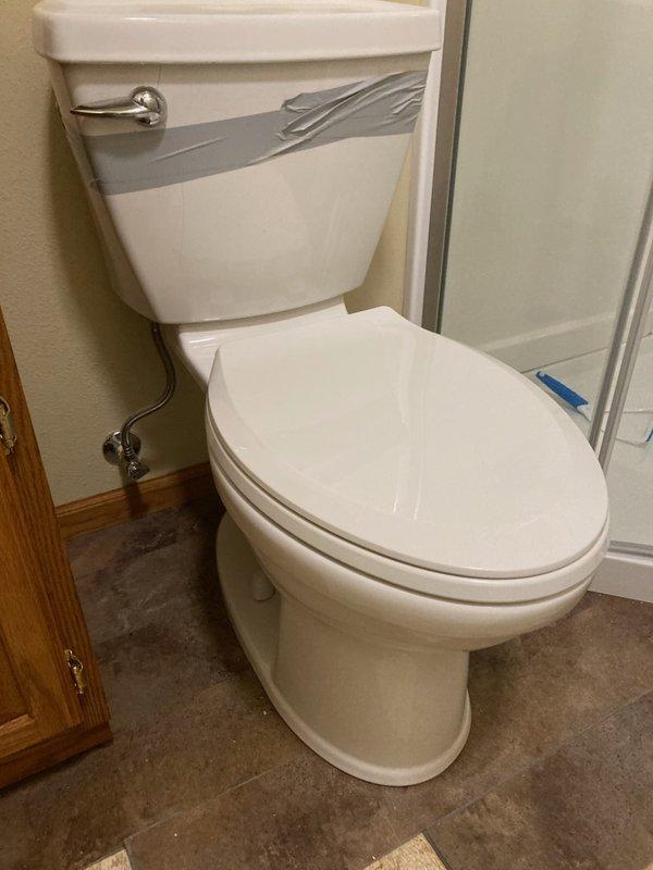 Responded to emergency plumbing call where a cracked toilet was discovered actively leaking and saturating the bathroom floor. Removed damaged two-piece toilet and disconnected water supply line at shut-off valve. Removed bathroom vanity with integrated sink and faucet assembly to allow access for flooring restoration. Coordinated with restoration company for water damage assessment and floor repairs. Fixtures removed and stored for disposal, with bathroom prepared for flooring contractor to complete repairs before new fixture installation can proceed.