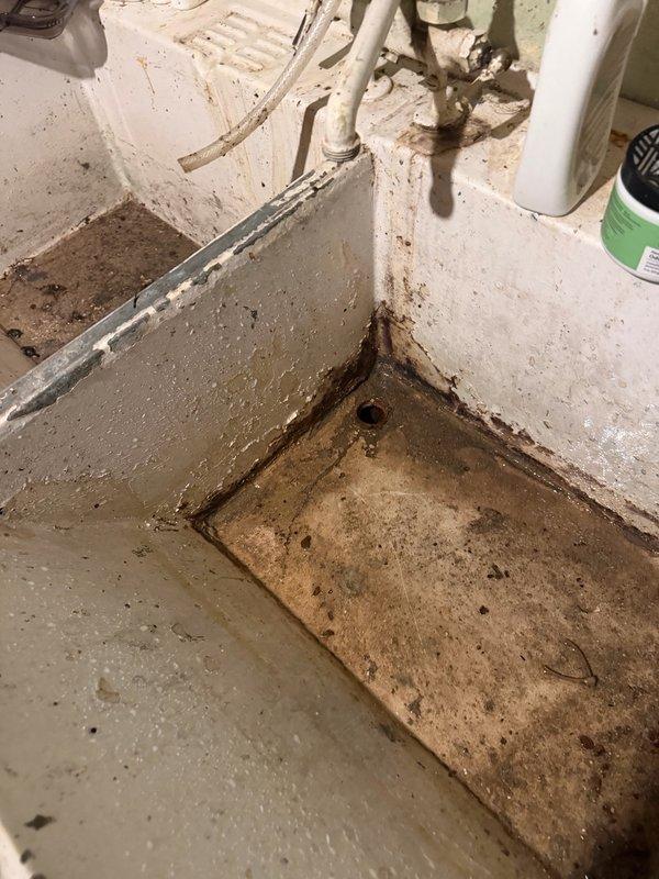 Responded to clogged laundry tub in basement utility area. The double-basin sink was backed up due to accumulated washing machine debris and lint buildup in the drain line. Deployed air snake to clear the obstruction, successfully restoring proper drainage. Ran water through both basins for five minutes to verify complete clearance and confirm system was draining at normal flow rate without backup.