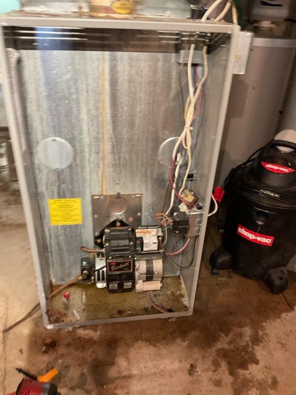 Responded to no cooling complaint and furnace fan continuously running. Diagnosed and replaced faulty thermostat, restoring proper system operation and resolving continuous fan issue. Investigated reported oil leak at filter location following previous maintenance visit. Inspected oil filter assembly and cleaned surrounding areas. Filter and gasket appeared secure with no active leaking observed. Identified loose fitting at bottom of oil tank as potential leak source. Advised customer that tank fitting requires attention from fuel company as it falls outside HVAC scope of work. Verified system cycling properly with new thermostat installed. All HVAC components functioning as designed upon completion.