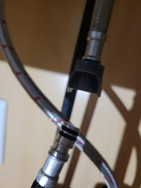 Responded to kitchen faucet issue where a plastic connector piece on the flexible supply hose had broken underneath the sink. Upon inspection, determined the existing faucet was an aftermarket unit without accessible model or serial number identification, making replacement part sourcing impractical. Removed failed faucet assembly and installed new kitchen faucet with proper supply line connections. Tested for leaks and verified proper hot and cold water flow and shutoff functionality. System restored to full operation.