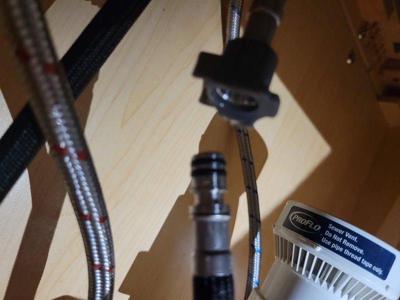 Responded to kitchen faucet issue where a plastic connector piece on the flexible supply hose had broken underneath the sink. Upon inspection, determined the existing faucet was an aftermarket unit without accessible model or serial number identification, making replacement part sourcing impractical. Removed failed faucet assembly and installed new kitchen faucet with proper supply line connections. Tested for leaks and verified proper hot and cold water flow and shutoff functionality. System restored to full operation.
