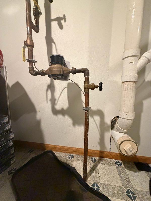 Replaced malfunctioning gate valve with 1" ball valve ahead of water meter. The existing gate valve was inoperable and failed to shut off water supply, which was discovered when city technicians replaced the water meter and had to use the curb valve at the street instead. Installed new ball valve on copper piping to provide reliable shut-off capability for future maintenance and emergency situations. System tested and verified proper operation of new shut-off valve.