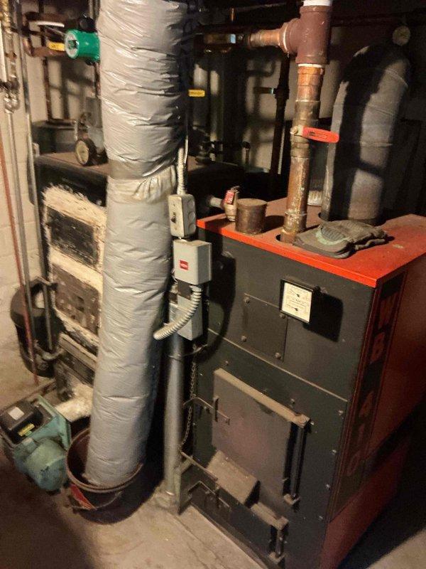Responded to water leak originating from main floor bathtub and draining into basement below. Upon inspection, identified failed galvanized tub drain as source of leak. Water damage restoration company had been previously contacted. Documented existing conditions with photographs of basement mechanical room showing proximity of leak to HVAC equipment and water heater. Diagnosed deteriorated galvanized drain piping requiring replacement. Provided estimate for replacement of affected drain section. Additionally assessed two-handled tub valve and provided bid for valve replacement with remodel plate to accommodate proper access and modernize fixture controls.