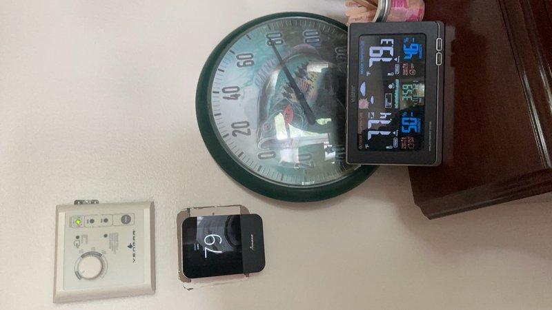 Responded to service call for Amana heat pump system with thermostat displaying inaccurate temperature readings. Upon arrival, found thermostat reading 84°F while actual room temperature was 79°F, a +5°F discrepancy. Noted multiple additional thermostats mounted in close proximity to the HVAC thermostat on the wall, which may have contributed to confusion. Accessed thermostat settings menu and performed calibration adjustment to correct the temperature offset. Verified accurate temperature display and provided instruction on proper thermostat calibration procedures. System confirmed operational with corrected temperature readings.