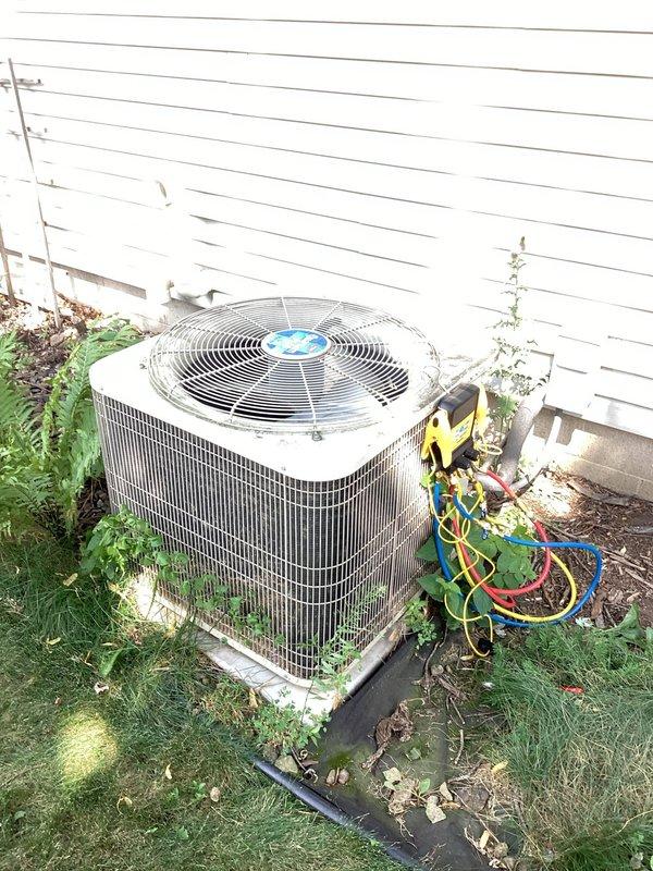Responded to no cooling call on 20+ year old residential air conditioning system. Upon inspection, diagnosed unit as low on refrigerant charge. Due to age of equipment and refrigerant loss, provided estimate for complete system replacement rather than repair. Unit photographed for documentation purposes.